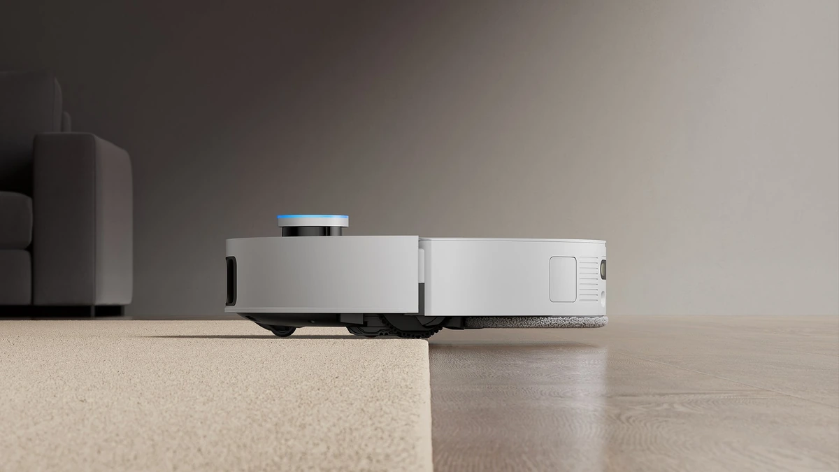 White Dreame X50 Ultra robot vacuum in side view on a floor, with its raised navigation sensor visible.