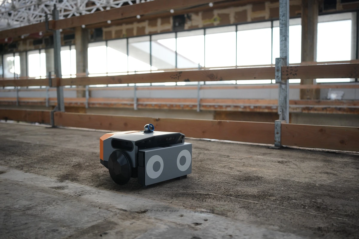 Dusty Robotics FieldPrinter 2 on the floor of a construction site.