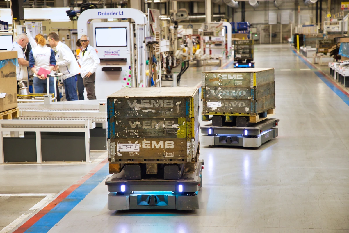 MiR250 mobile robots carrying material loads at Forvia.